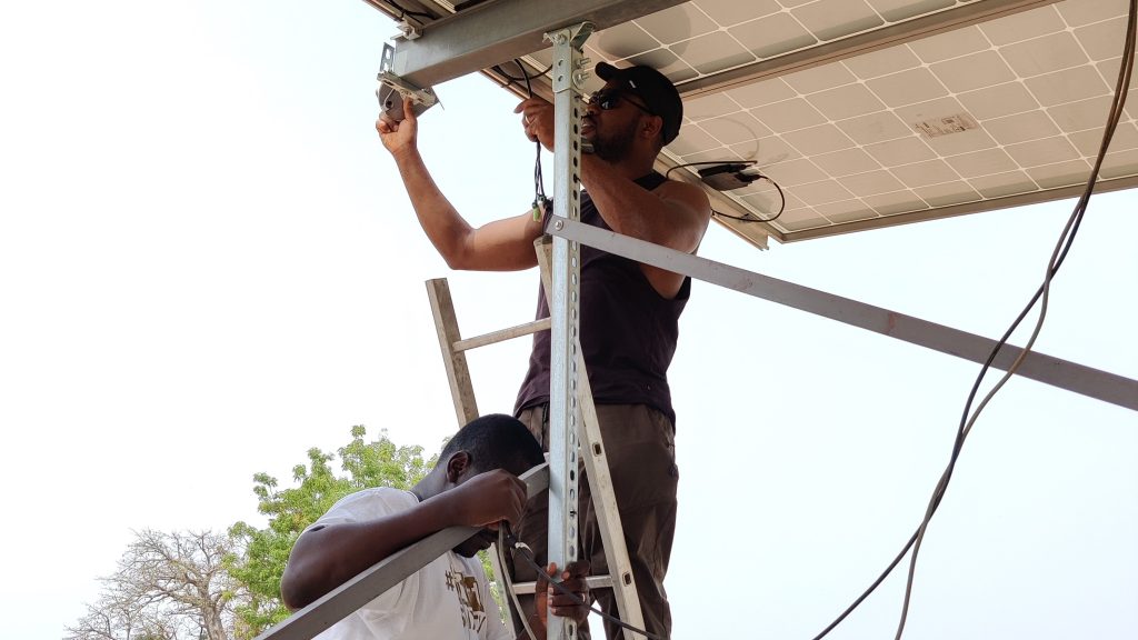 Two men working on a solar panel installation